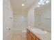 Bathroom with a combined shower and tub, a sink, and wood cabinetry for storage at 2594 Berrington Loop, The Villages, FL 32162