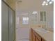 Bright bathroom with shower stall, vanity, and access to the primary bedroom at 2594 Berrington Loop, The Villages, FL 32162