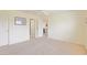 A carpeted bedroom provides access to both an ensuite bathroom and a dining room at 2594 Berrington Loop, The Villages, FL 32162