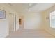 A carpeted bedroom provides access to both an ensuite bathroom and another room at 2594 Berrington Loop, The Villages, FL 32162