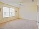 Bright bedroom featuring a ceiling fan and a large window that provides natural light at 2594 Berrington Loop, The Villages, FL 32162