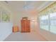 Bedroom with neutral carpet, a ceiling fan, and natural light from a window at 2594 Berrington Loop, The Villages, FL 32162