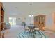 Bright dining area with a glass-topped table, carpeted floor, and sliding glass door at 2594 Berrington Loop, The Villages, FL 32162