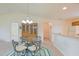 Bright dining room features a glass table, chandelier, and lovely built-in wooden cabinet at 2594 Berrington Loop, The Villages, FL 32162