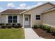 Home with a well-maintained front yard and mulch flower bed, sidewalk leading to the entrance at 2594 Berrington Loop, The Villages, FL 32162