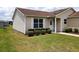 Charming home with manicured lawn, complemented by well-placed shrubbery around the house at 2594 Berrington Loop, The Villages, FL 32162