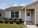 Home featuring a well-kept front yard with mulch beds and sidewalk leading to the front door at 2594 Berrington Loop, The Villages, FL 32162