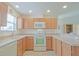 Efficient kitchen space showcasing ample countertop space, white appliances, and overhead lighting at 2594 Berrington Loop, The Villages, FL 32162
