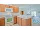 Open kitchen layout blending functionality with a counter overlooking the living area at 2594 Berrington Loop, The Villages, FL 32162