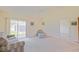 Bright living room with neutral carpet and sliding door access to the screened-in porch at 2594 Berrington Loop, The Villages, FL 32162