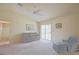Cozy living room featuring neutral carpet, a ceiling fan, and sliding door access to the outside at 2594 Berrington Loop, The Villages, FL 32162