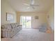 Spacious living room with ceiling fan, sliding glass doors and comfortable seating at 2594 Berrington Loop, The Villages, FL 32162