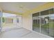 An enclosed patio features sliding glass doors and a ceiling fan for relaxation and comfort at 2594 Berrington Loop, The Villages, FL 32162