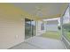 A covered patio has sliding glass doors, a ceiling fan, and screens for enjoying the outdoors at 2594 Berrington Loop, The Villages, FL 32162
