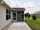 Exterior of screened-in patio with concrete flooring, ample natural light, and backyard views at 2594 Berrington Loop, The Villages, FL 32162