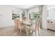 Dining area featuring modern table, chairs, chandelier and natural light from the sliding glass doors at 2937 Ne 21St Terrace Rd, Ocala, FL 34470