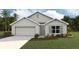 Charming single Gathering home featuring a two-car garage and a well-manicured lawn and lovely landscaping at 2937 Ne 21St Terrace Rd, Ocala, FL 34470