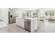 Open concept kitchen features an island with a stainless steel dishwasher and a view into the living room at 2937 Ne 21St Terrace Rd, Ocala, FL 34470