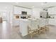 Bright kitchen featuring white cabinetry, stainless steel appliances, and a spacious island with bar stool seating at 2937 Ne 21St Terrace Rd, Ocala, FL 34470
