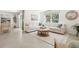 Bright and airy living area featuring tile flooring, large sectional sofa, and views into the dining area at 2937 Ne 21St Terrace Rd, Ocala, FL 34470