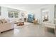 Cozy living room features a comfortable sofa, stylish decor, a large window and a view into the bedroom at 2937 Ne 21St Terrace Rd, Ocala, FL 34470