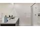 Bathroom with double sink vanity, stone countertops, and a shower at 2945 Ne 21St Terrace Rd, Ocala, FL 34470