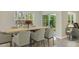 Dining room with large window and sliding glass door, wood table and seating for eight at 2945 Ne 21St Terrace Rd, Ocala, FL 34470
