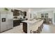 Bright kitchen with stainless steel appliances, dark cabinets, and a large island with bar seating and an adjacent dining area at 2945 Ne 21St Terrace Rd, Ocala, FL 34470
