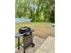 Grill in backyard with patio, grassy area, and a white fence for a relaxing and private outdoor space at 3106 Silver Palm Dr, Edgewater, FL 32141