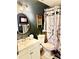 Charming bathroom featuring a rustic shower curtain, oval mirror and ample lighting at 3106 Silver Palm Dr, Edgewater, FL 32141