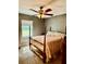 Bedroom with a four-poster bed, ceiling fan, and a window letting in natural light at 3106 Silver Palm Dr, Edgewater, FL 32141