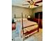 Bedroom with a four-poster bed, ceiling fan, and a window letting in natural light at 3106 Silver Palm Dr, Edgewater, FL 32141