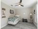 Bright bedroom with ceiling fan, plank flooring, and stylish décor at 32 Pine Course Loop, Ocala, FL 34472