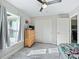 Bright bedroom features wood-look flooring, ceiling fan, and natural light at 32 Pine Course Loop, Ocala, FL 34472