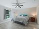 A calm bedroom featuring a ceiling fan, nightstands, and a window at 32 Pine Course Loop, Ocala, FL 34472