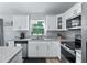 Well-equipped kitchen featuring granite countertops, stainless steel appliances, and lots of natural light at 32 Pine Course Loop, Ocala, FL 34472