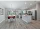 Bright kitchen featuring stainless steel appliances, an island, and an adjacent dining area at 32 Pine Course Loop, Ocala, FL 34472