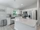 Modern kitchen featuring white cabinetry, stainless steel appliances, and a granite countertop island at 32 Pine Course Loop, Ocala, FL 34472