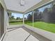 Relaxing screened-in patio with ceiling fan overlooking the lush backyard at 32 Pine Course Loop, Ocala, FL 34472