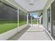 Screened-in lanai offering serene backyard views and outdoor relaxation space at 32 Pine Course Loop, Ocala, FL 34472