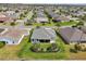 Aerial view of home featuring screened lanai, manicured lawn, and mature landscaping at 3500 Countryside Path, The Villages, FL 32163