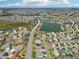 Aerial view of community featuring homes surrounding lakes and a golf course at 3500 Countryside Path, The Villages, FL 32163