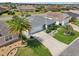 Overhead shot of a home, with a spacious driveway, lush landscaping, and a two-car garage at 3500 Countryside Path, The Villages, FL 32163