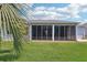 Expansive backyard featuring a screened-in lanai with beautiful landscaping at 3500 Countryside Path, The Villages, FL 32163