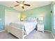 Charming bedroom with ceiling fan, beachy decor, and white wood furniture at 3500 Countryside Path, The Villages, FL 32163