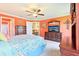 Bedroom featuring orange walls, carpet, ceiling fan, and multiple dressers at 3500 Countryside Path, The Villages, FL 32163