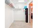 Carpeted walk-in closet with wire shelving and a dark wooden cabinet at 3500 Countryside Path, The Villages, FL 32163