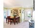 Cozy dining area with a wooden table set for four, adjacent to the entry at 3500 Countryside Path, The Villages, FL 32163