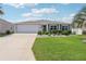 Charming single-story home with a well-manicured lawn and a two-car garage at 3500 Countryside Path, The Villages, FL 32163