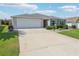 Single-story home with a two-car garage and a well-maintained concrete driveway at 3500 Countryside Path, The Villages, FL 32163